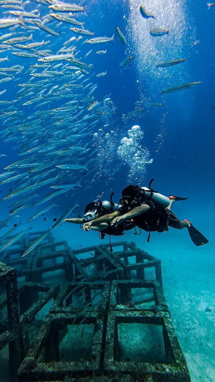 SSS Phuket instructor guiding Discover Scuba Diving student underwater